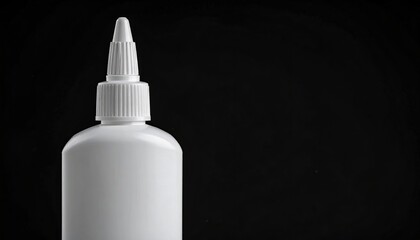 White bottle of glue on a black background