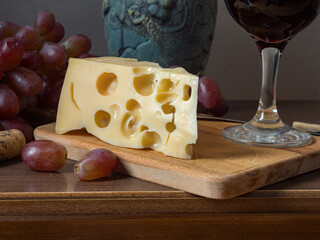 Wine, cheeses and grapes in a vintage setup.