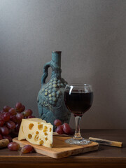 Wine, cheeses and grapes in a vintage setup.