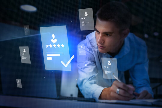 Young professional reviewing digital resume documents at night in a modern office setting with glowing graphics