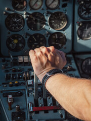 Pilot's hand pushing thrust lever for takeoff in a cockpit of an aircraft