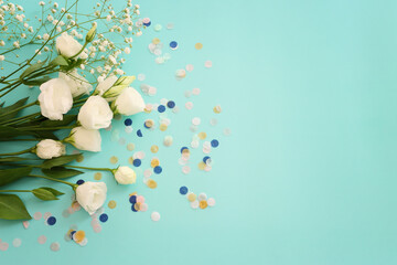 Top view image of white flowers composition over blue background .Flat lay