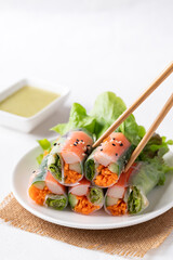 Salad roll with crab stick, carrot, cucumber and lettuce wrapped with rice paper eating with dipping sauce