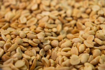 Dry peanuts with salt roasted without skin. Side view background. Healthy spices, nuts, seeds and plant products.
