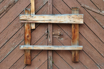 Old Timber Garage Door closed with Nailed Wooden Planks
