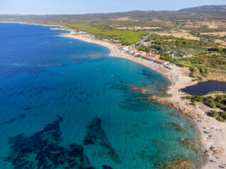 Aerial view of the beautiful beach of Vignola Mare with its tower