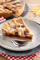 Slice of traditional Pastafrola pie with guava filling, also known as Cuban pae on rustic wooden table