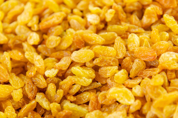 Background with golden raisins. Food texture. Top view of dried grapes