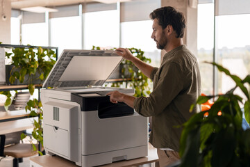 Office worker using multifunction printer in the office