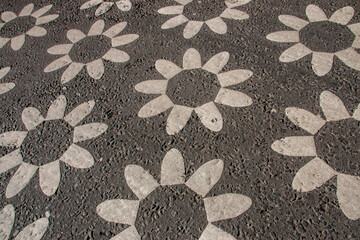 A view of sunflowers painted onto a road walkway