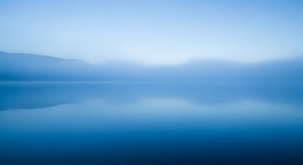 Fototapeta premium Misty Blue Lake Landscape, Soft Focus, Calm Atmosphere.