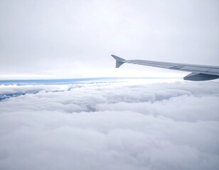 Fototapeta premium High-altitude view of a plane wing above a vast expanse of soft, white clouds.