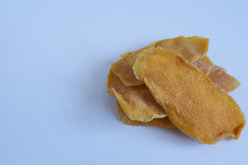 Dried mango slices on white background. Close up. Selective focus.