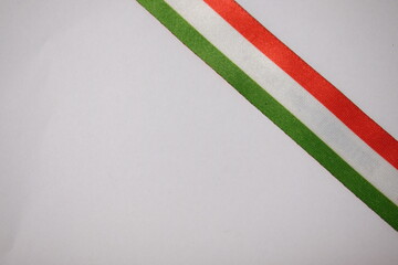 Naklejka premium Diagonal Hungarian tricolor ribbon on white background, symbolizing national identity.