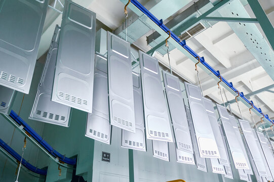 Metal parts undergo degreasing and rinsing process in a powder coating workshop