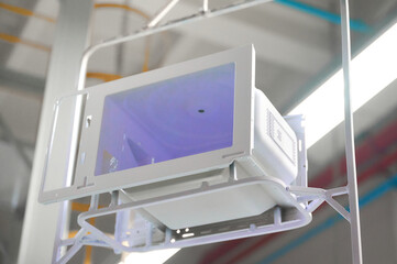 Microwave oven casings on overhead conveyor in a powder coating workshop during production process