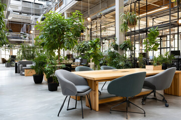 Fototapeta premium Modern industrial office with contemporary furniture and plants for Teams background