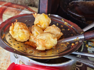 Golden Indonesian Street Food: A Deep-Fried Culinary Delight of Savory Fritters, a Staple Snack of Local Culture and Flavor