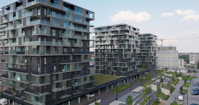 Aerial view of a premium residential complex in Katowice, Poland, with modern glass balconies, landscaped surroundings, and contemporary architectural design in a growing urban neighborhood.