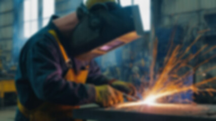 Fototapeta premium blurry image of someone welding iron, there are sparks, the person is wearing safety clothing, blurry wallpaper