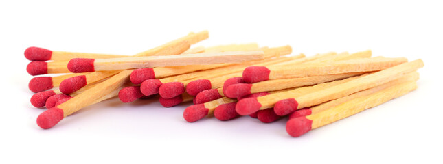 Pile of wooden matches with red heads isolated on white