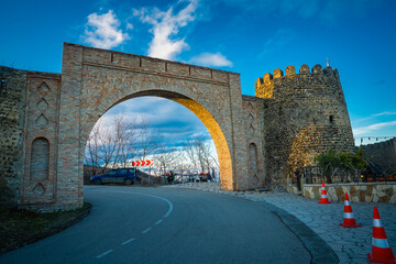 Sighnaghi Fortress Arch in beautiful evening light as the road cures around it