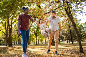 Joyful family moments under colorful autumn trees in the park