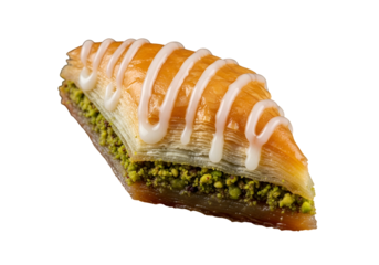 A triangular baklava, filled with pistachios, is drizzled with white icing, creating a delectable dessert image.
