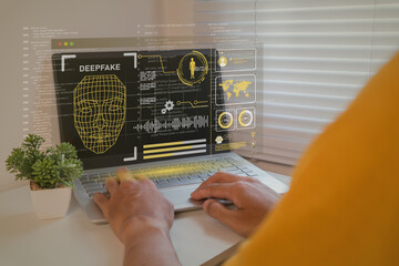 Deepfake concept. Man using a laptop to create convincing fake image, video and audio recording.