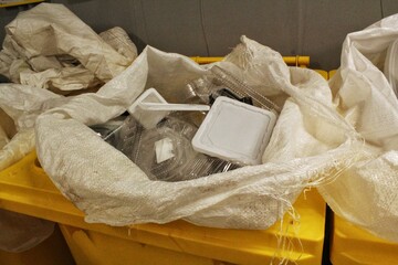 Bag Full of Mixed Plastic Recycling Waste. Clear and White Plastic Items for Recycling in bin. Plastic Packaging Waste in a Sack. Recyclable Plastic Containers in a Bag. Polymer Waste for Recycling