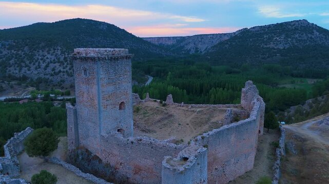 Aerial view from a drone of the sunset at the castle in the town of Ucero, in the Burgo de Osma region, Soria Province, Autonomous Community of Castile and Leon, Spain. Europe