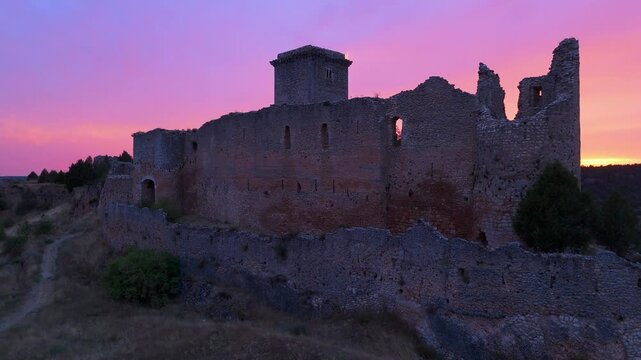 Aerial view from a drone of the sunset at the castle in the town of Ucero, in the Burgo de Osma region, Soria Province, Autonomous Community of Castile and Leon, Spain. Europe