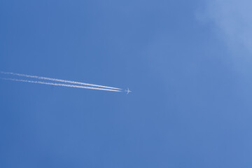 Jet and contrail clouds on blue sky