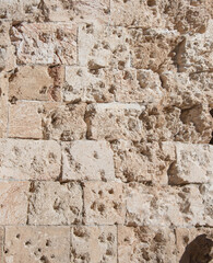 Close-up stones of wall damaged by bullets, shells and missiles. Jerusalem.