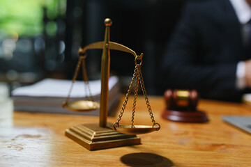 judge on wooden table And experienced lawyers meet with clients and give advice behind the scenes. legal services legal consulting concept
