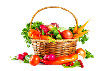 Fresh shiny different vegetables in a wicker basket. Isolated on white background.