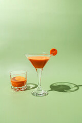 Fresh carrot juice on green background