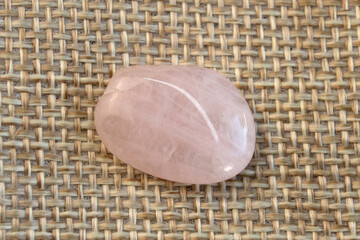 Several pieces of polished pink quartz on textured background. Minimal color still life photography