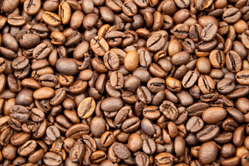 Photo of Big pile of fresh roasted coffee beans close up. Food photo