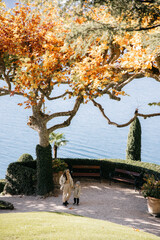 Mother and child enjoying autumn colors by lake como