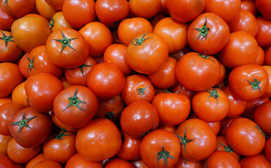fresh organic red tomatoes, vibrant heap of juicy ripe tomatoes, organic market, for food markets, healthy eating, organic farming, nutrition blogs, and grocery promotions.
