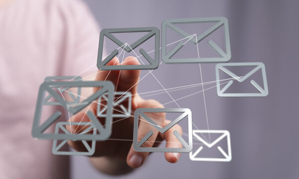 Hand interacts with digital email icons, representing global communication and networking.