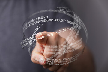 A finger interacts with a sphere of digital code, highlighting the concept of data visualization and interaction.