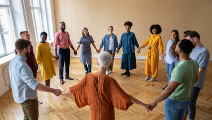 Photo of a diverse group of people holding hands in a circle, fostering a sense of community and connection
