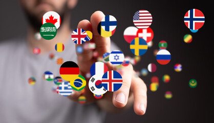 Image of a hand interacting with flags of various countries, representing global connections and international relations.