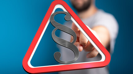 Stock photo of a hand pointing at a red triangle warning sign with a paragraph symbol.  Perfect for...