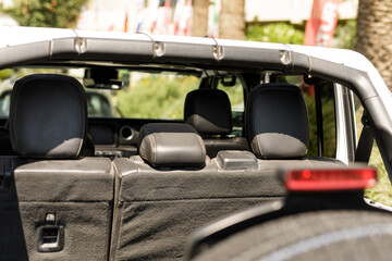 Stock photo of a white Jeep Wrangler's back seats and interior. Perfect for automotive, travel, or adventure themes.