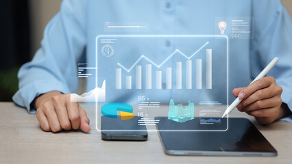 Businessman using tablet with data analytics dashboard, digital chart, business intelligence and big data technology concept