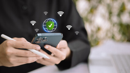 Hand holding smartphone with secure internet globe shield icon, safe wifi connection and online protection concept
