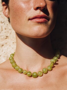 Editorial portrait of Italian woman with Mediterranean beauty and jewelry. Close-up photography with rustic background, inspired by Italian fashion and lifestyle